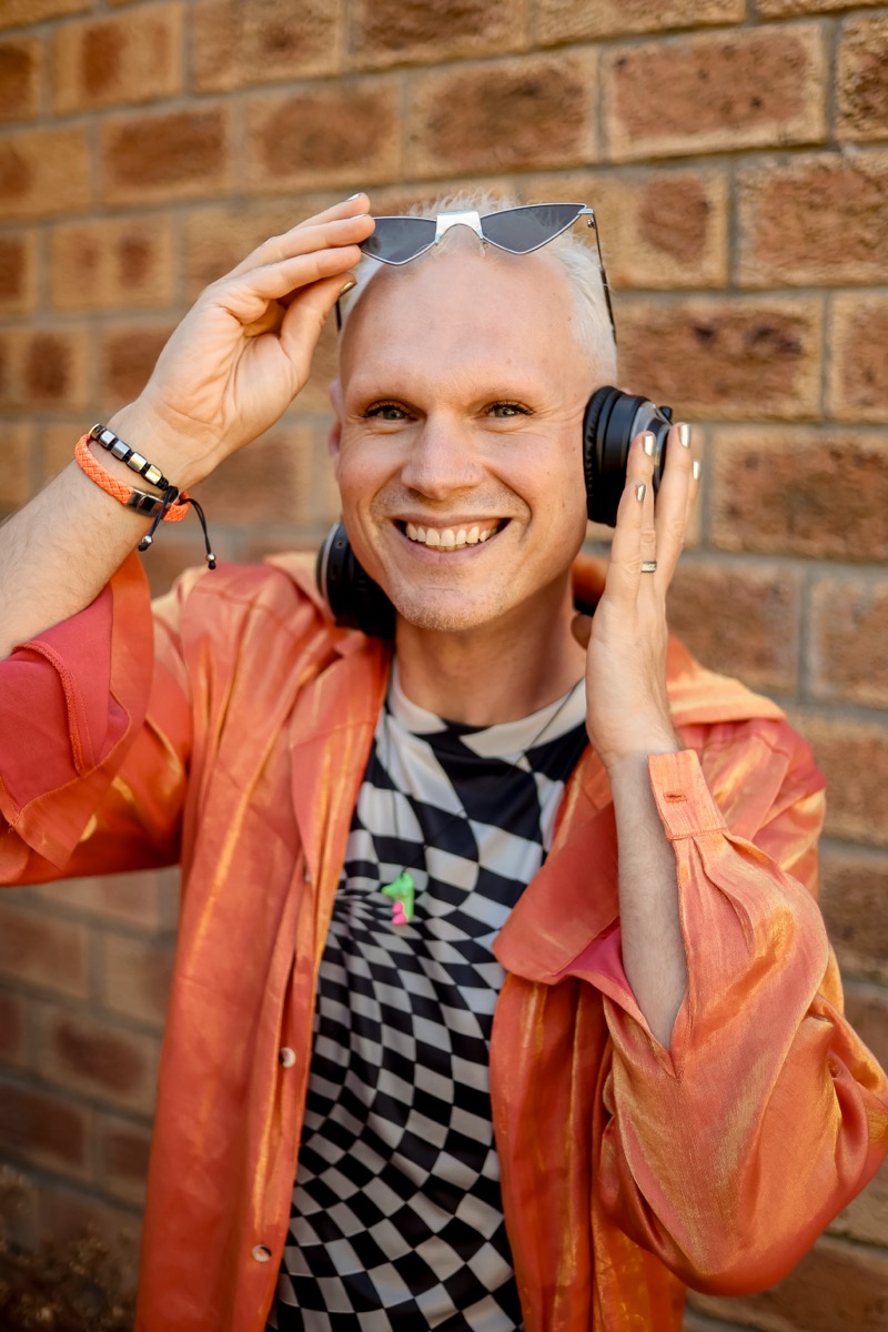 Samuel L. Rose smiling with headphones around his neck.
